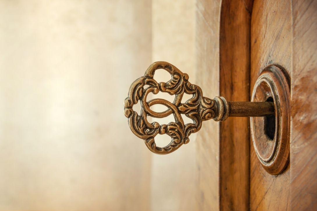 old ornate key in a wooden door