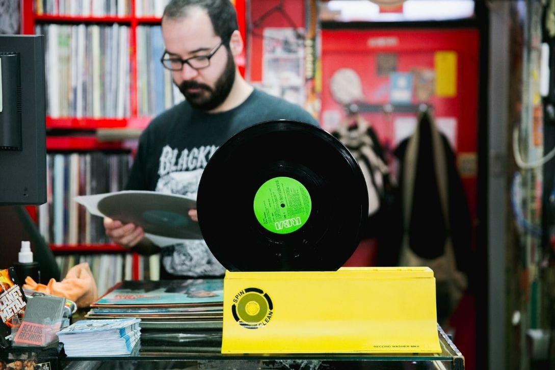 man at beatdisc records holding a vinyl