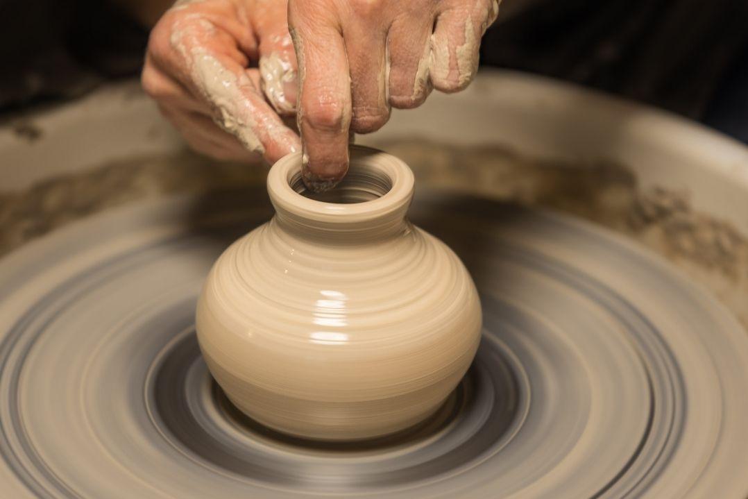 pottery spinning clay on a wheel