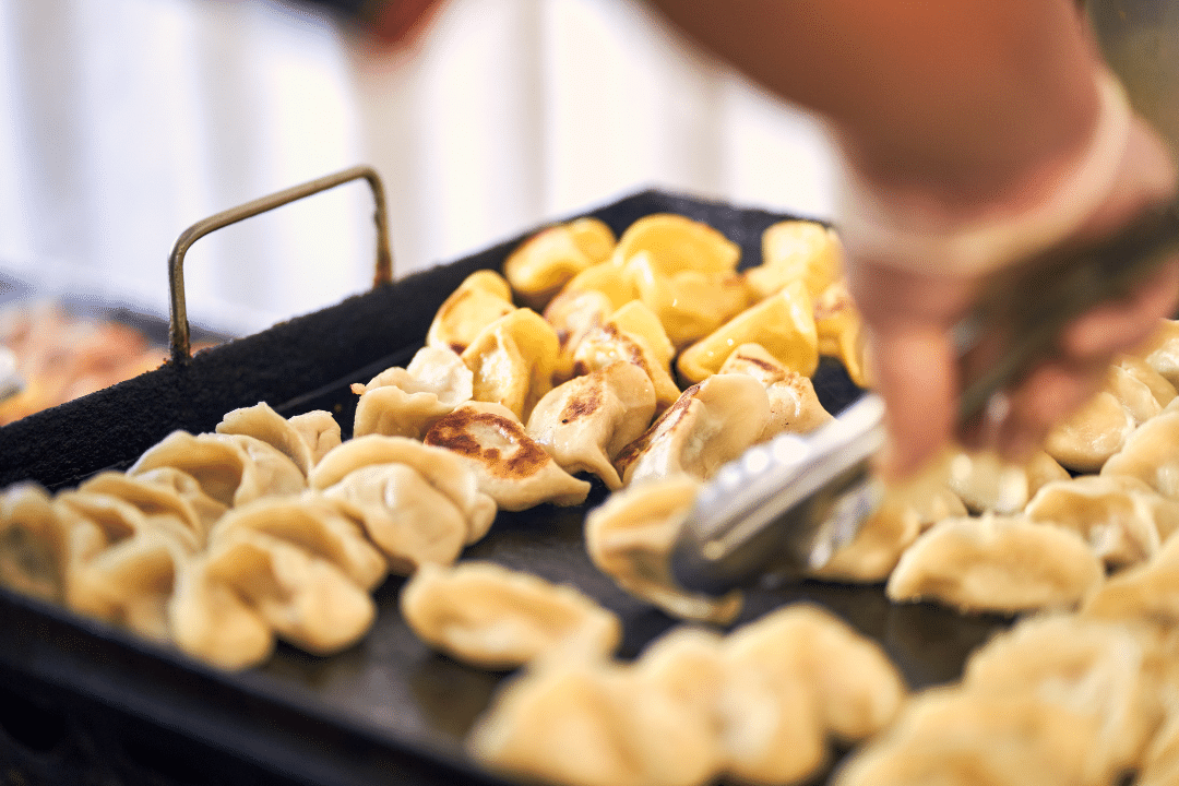 A person cooking dumplings.