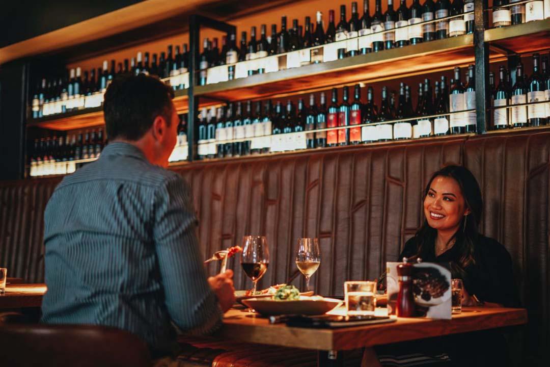 A couple dine at Meat & Wine Co Parramatta