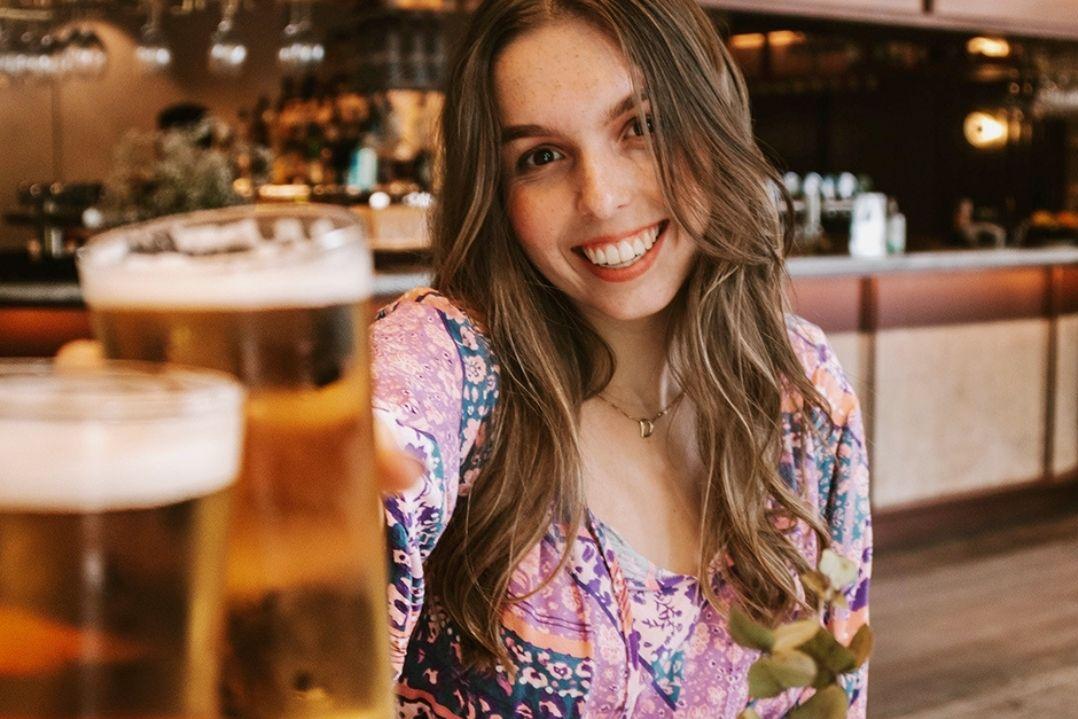 A woman having a beer with friends.