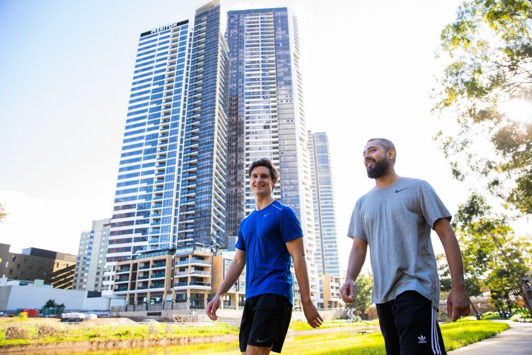 two men walking along parramatta river in work out clothes