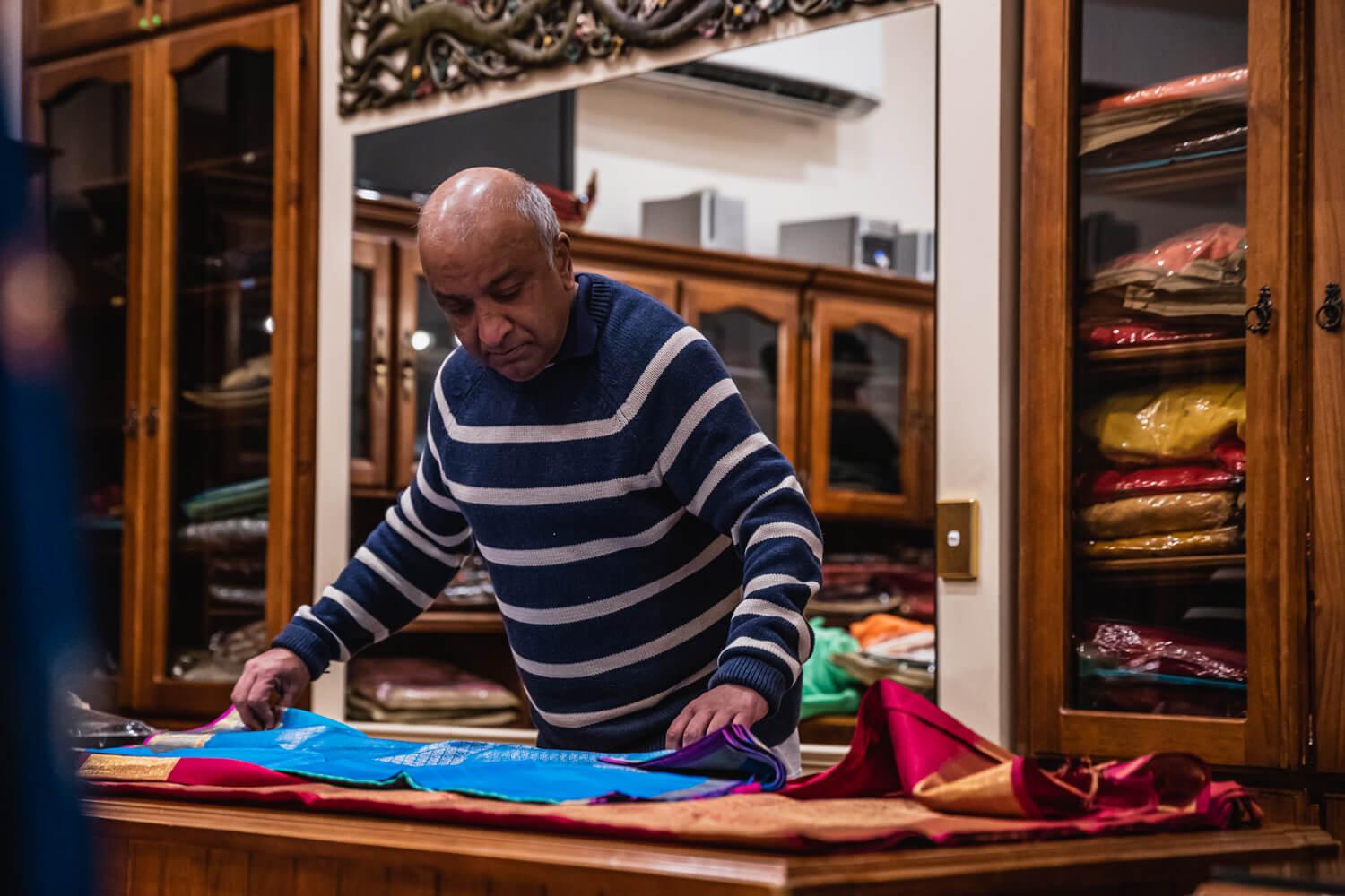 Store Owner Measuring Fabric