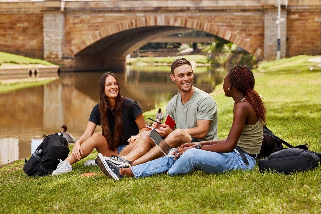 3 Students Sitting By Parramatta River