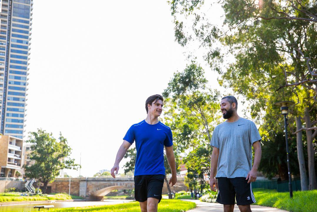 Two men exercising along the Parramatta River.