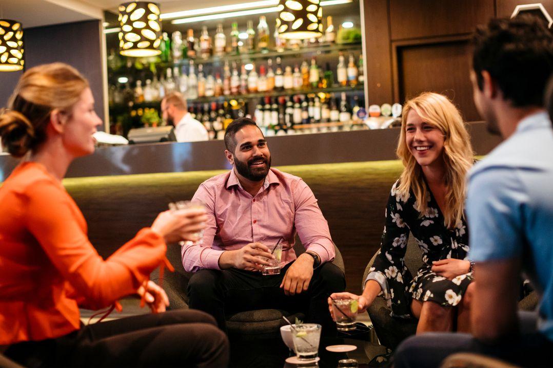 people enjoying drinks together in a bar