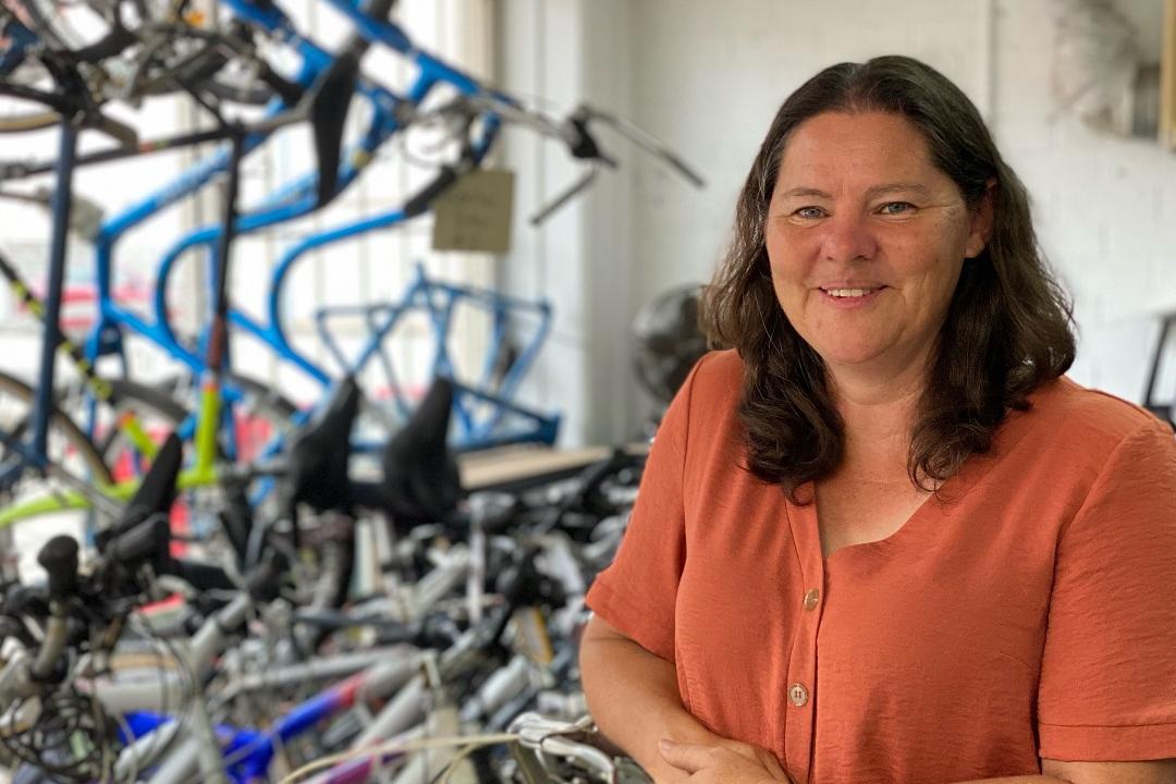 Woman standing in front of bicycles