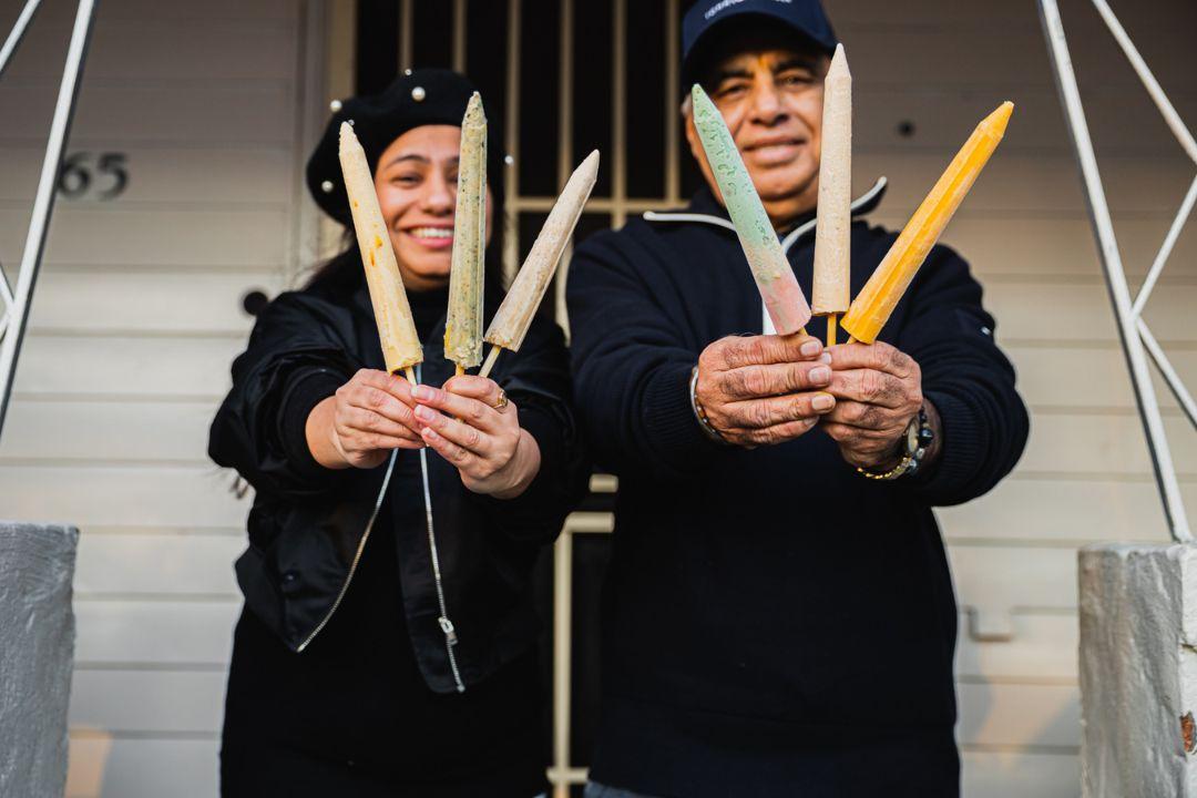 Two people holding Kulfti ice cream