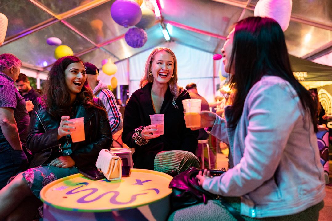 three smiling women with drinks 