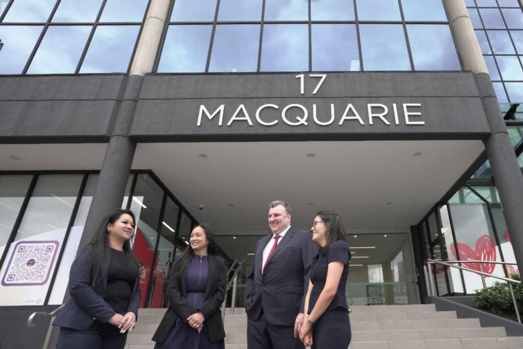 3 people standing outside a building