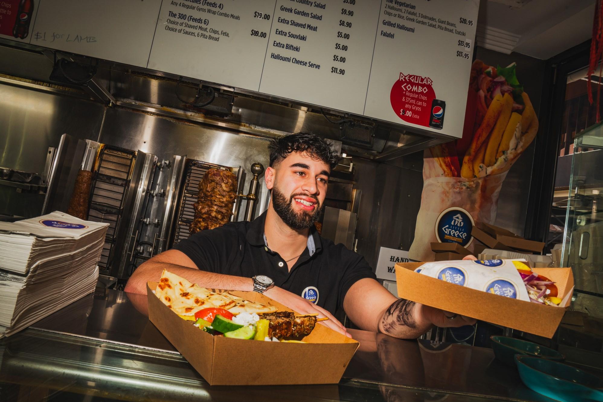 Man serving food in cardboard boxes