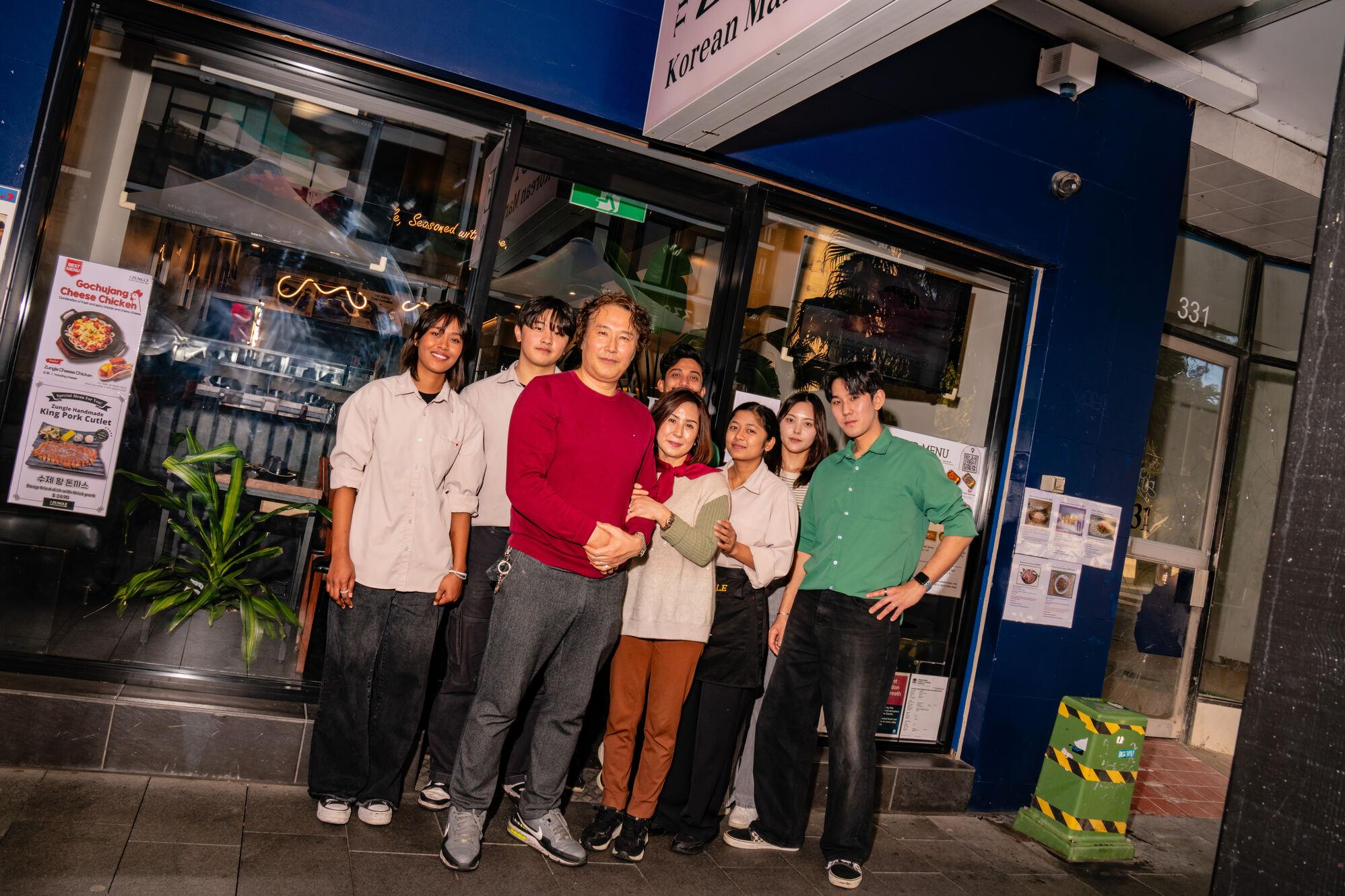 Group of people standing outside a restaurant