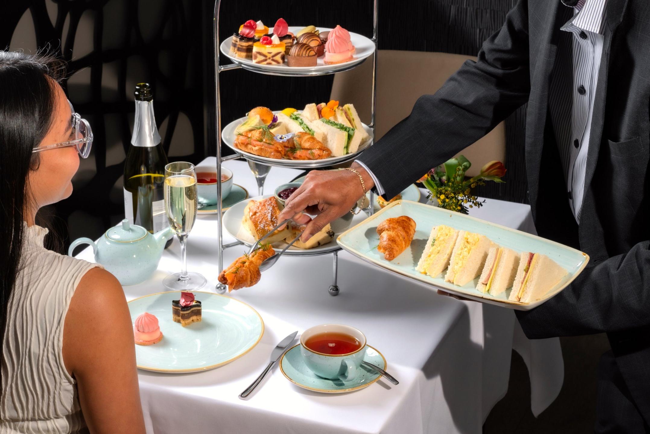 Woman being served high tea