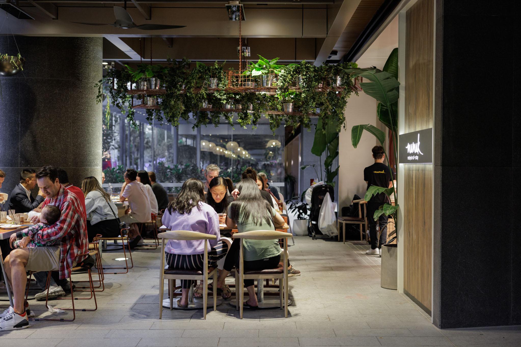 Customers sitting inside a store eating