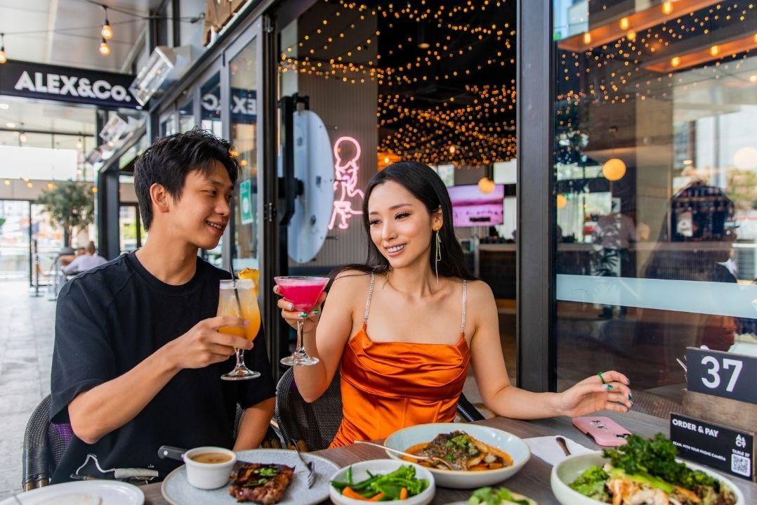 Couple enjoying a meal at Alex & Co