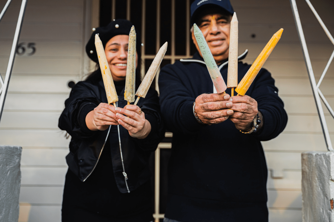 two people holding kulfti