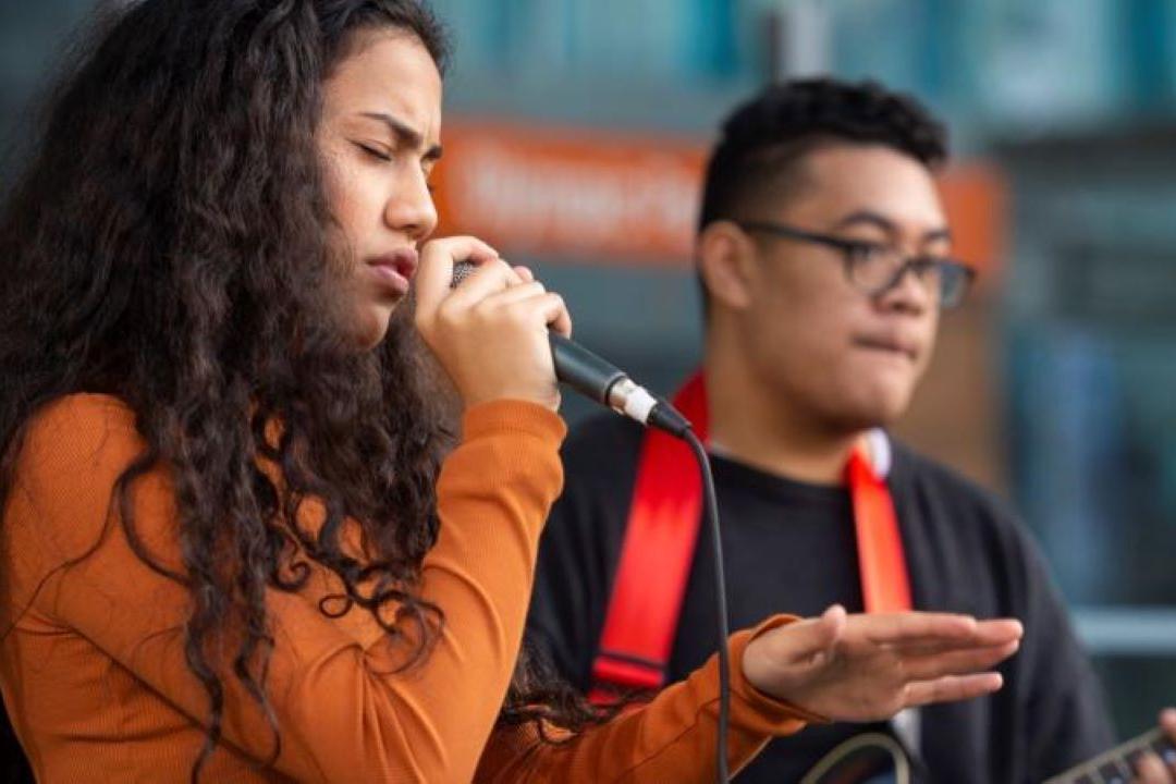 Lady singing in Mic