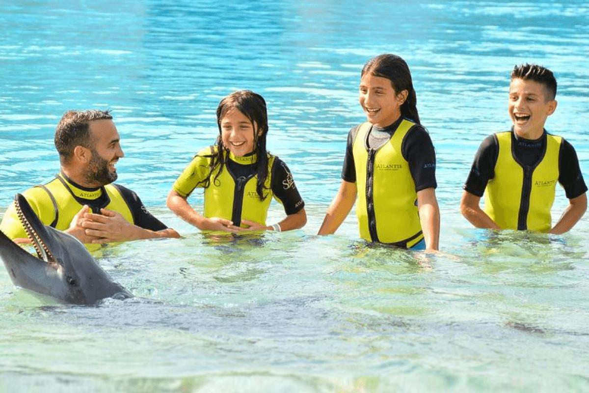 Family in the water with Dolphin