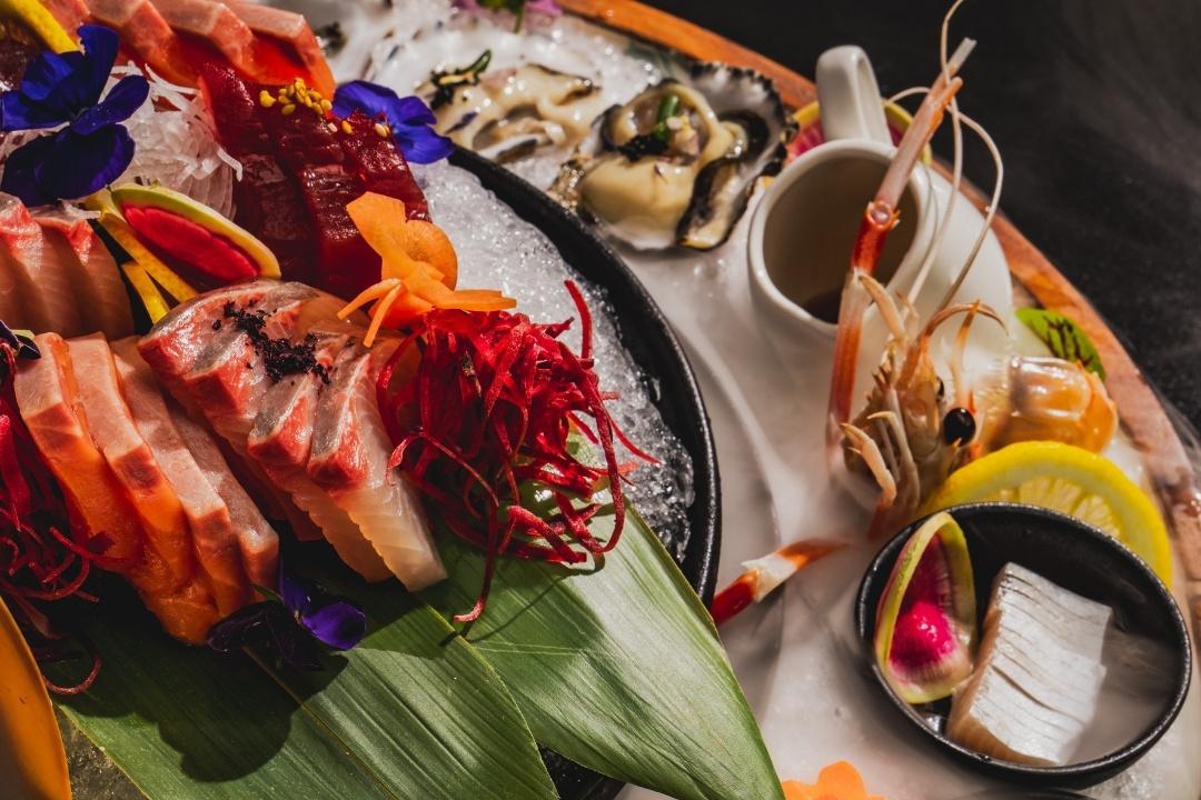 Fresh sashimi on a platter with prawns
