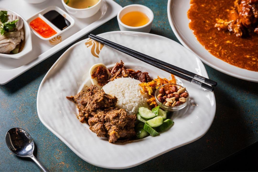 Bowl of rice and meat dish with cucumber