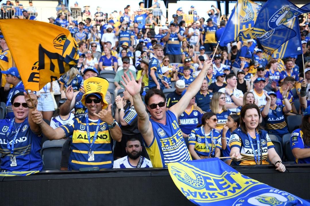 Cheer fans in the stands wearing yellow and blue