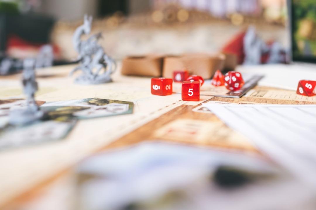 Role playing game with dice and character sheets on a table