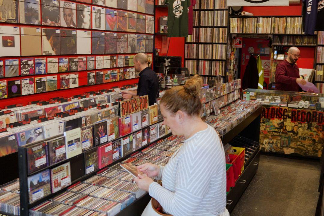 Woman looking at CDs in a large room of CDs and records