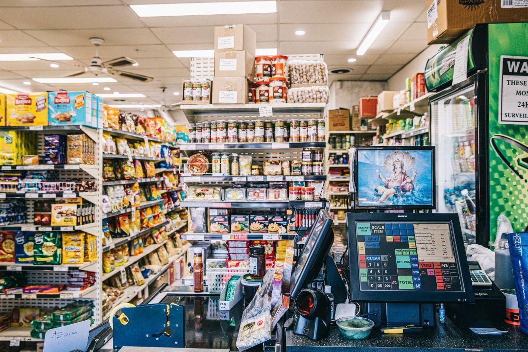 Inside a busy convivence store full of shelving units of stock
