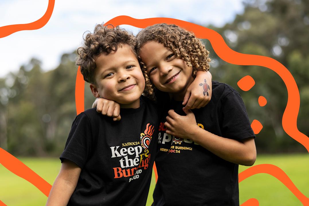 Two kids with their arms around each other and smiling