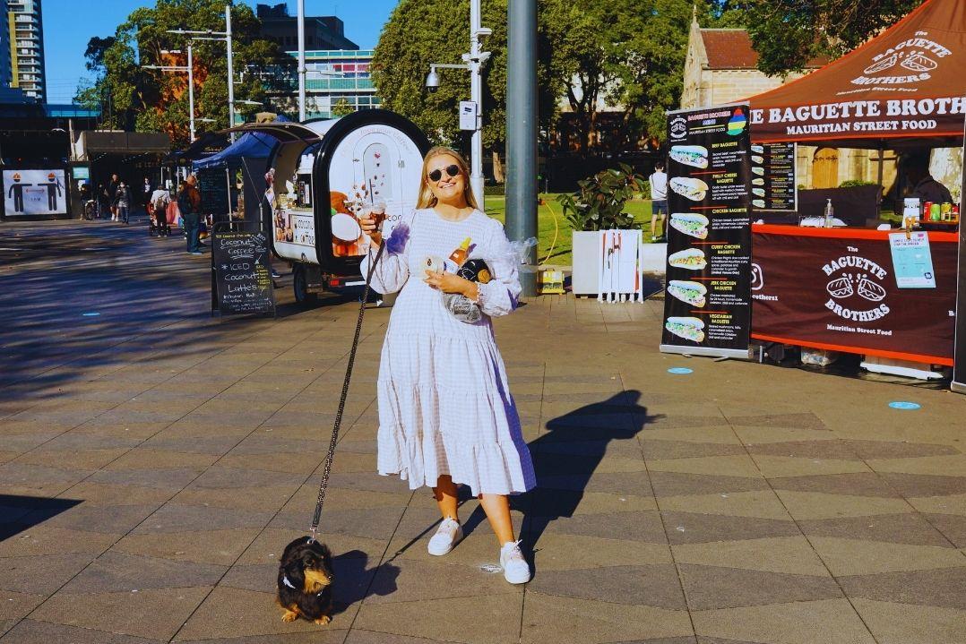 Woman in white standing in front of empty street