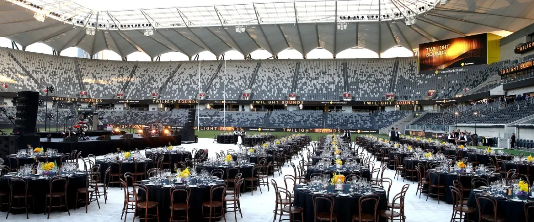 Commbank Stadium set up with round tables and banquet seating on field