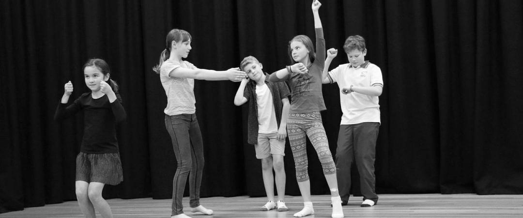 Kids performing on a stage together