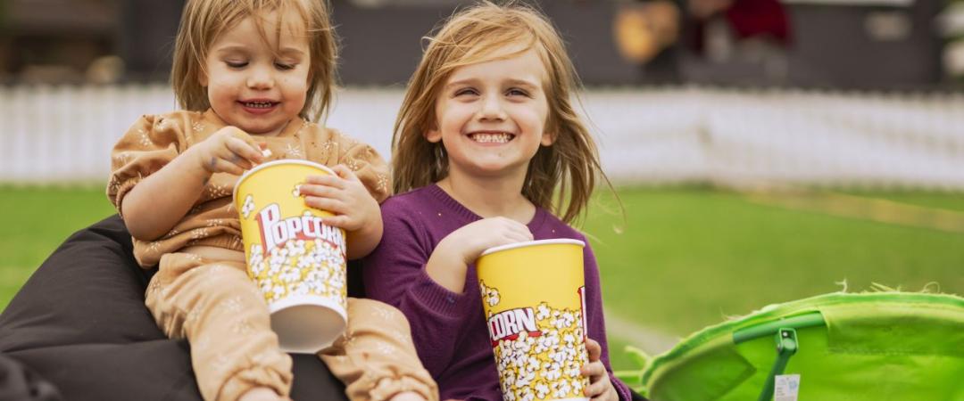 Children eating popcorn on beanbag