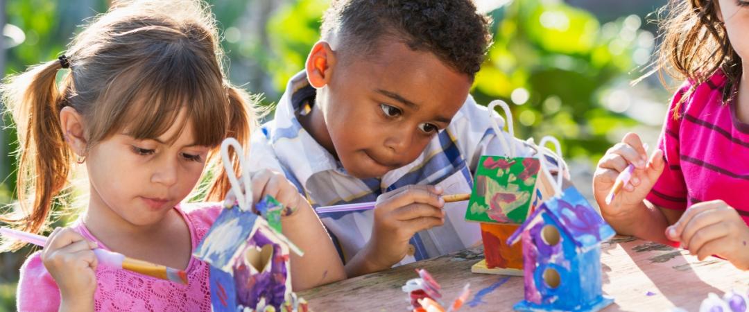 Children painting birdhouses