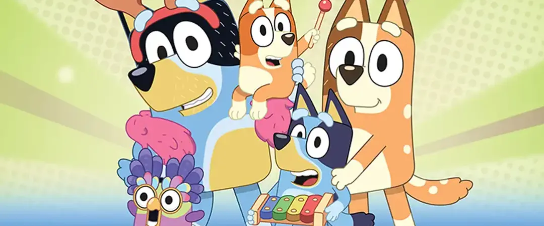 Cartoon dogs and a costumed bird stand joyfully against a starburst background. They display playfulness, with one holding a xylophone.