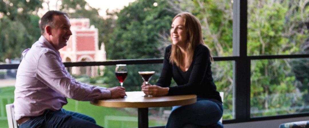 couple enjoying wine at table overlook Parramatta park