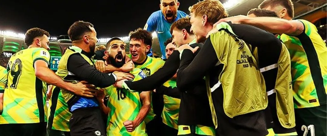 Soccer team celebrating a victory under stadium lights. Players in green vests embrace and cheer joyfully, exuding excitement and unity.
