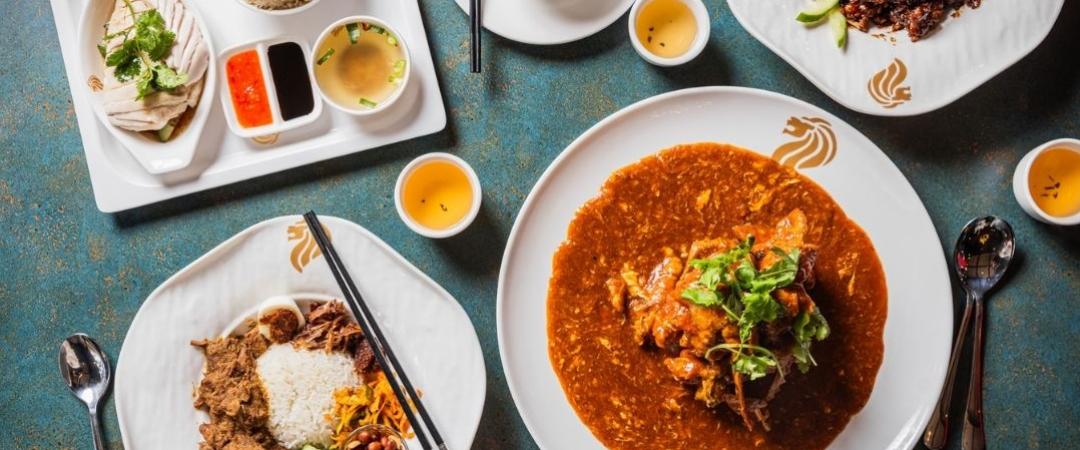 Yummy food on table like rice and chicken, laska and satay chicken