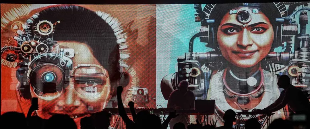 Silhouetted crowd faces a stage with musicians and large screens showing vibrant digital portraits of women with futuristic, mechanical features. Energetic ambiance.