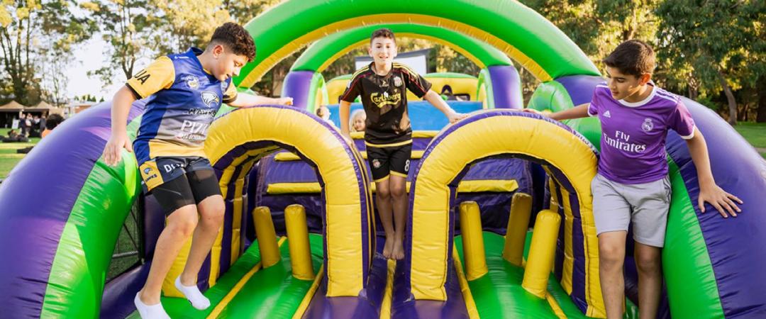 Kids on inflatable obstacle course