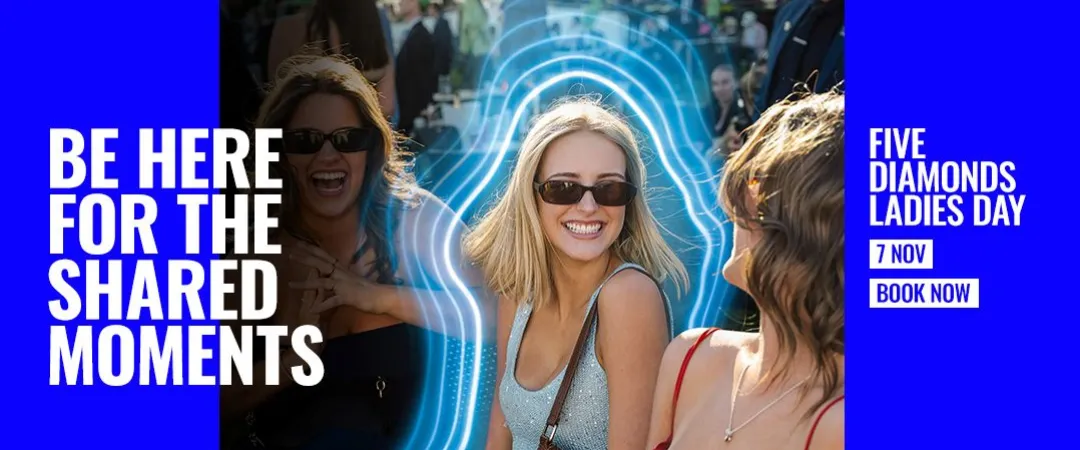 Three people wearing sunglasses chat and socialise in the foreground