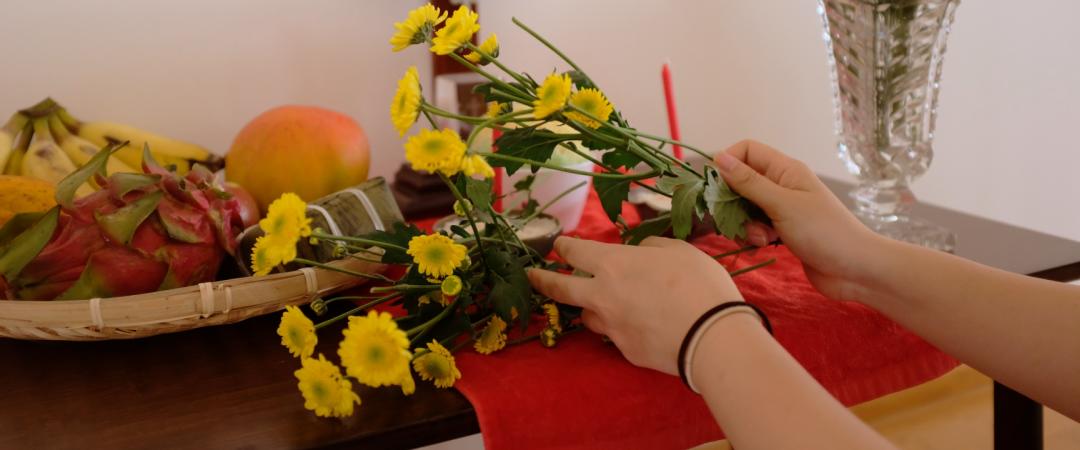 Two hands arranging flowers