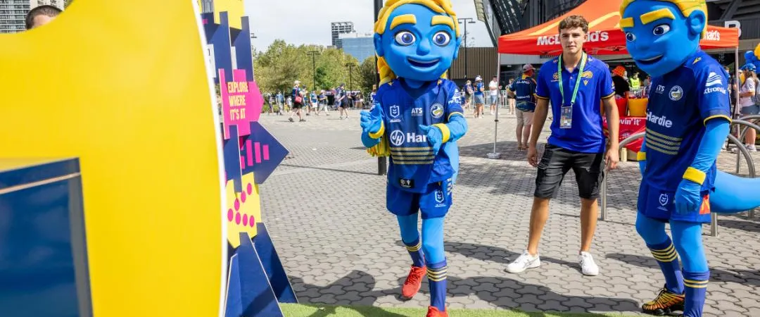 Blue mascots throwing a football