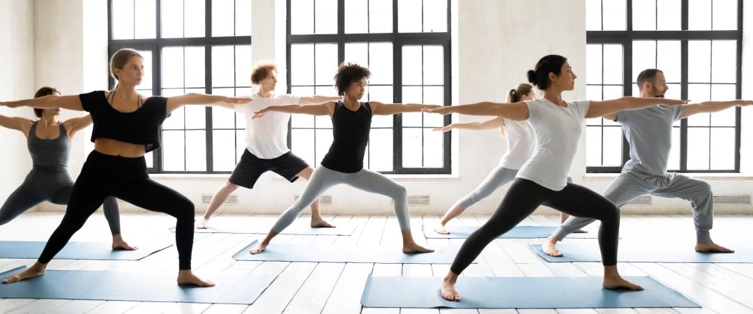 Men and women doing yoga on yoga mats