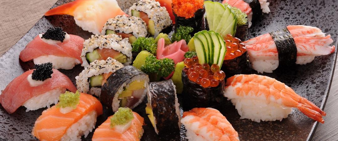 Assorted sushi platter on square black plate