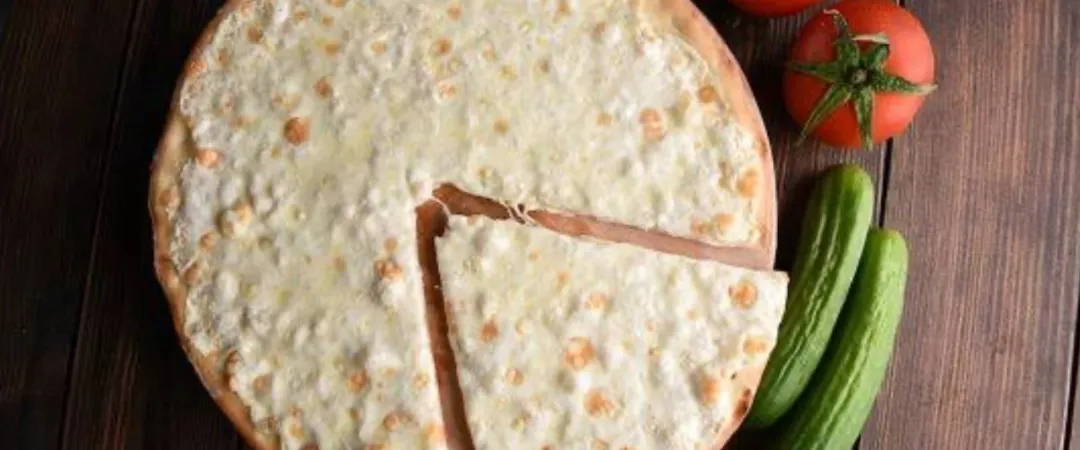 cheese pizza with vegetables on the side