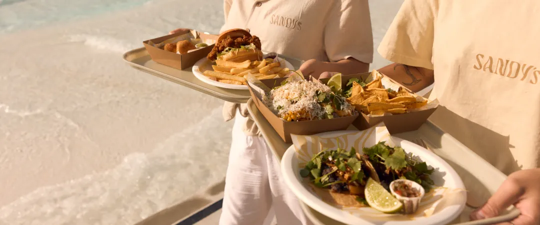 people holding a platter of food