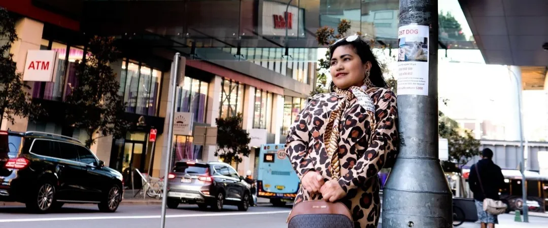 woman standing outside Westfield Parramatta holding handbag