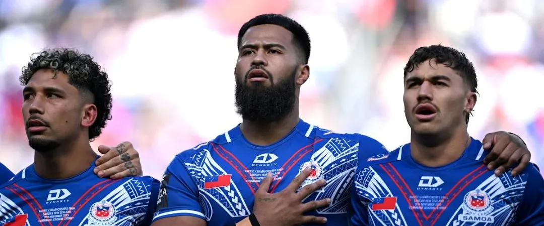 3 men in blue and white rugby jerseys with hands on heart